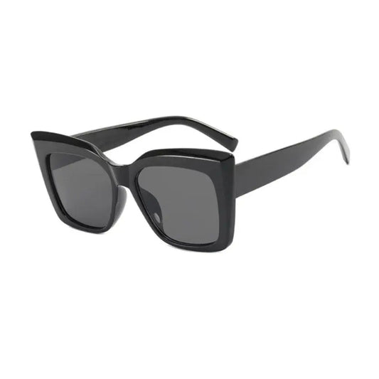Close-up of MODERN black sunglasses with black frames, offering polarized UV-400 protection. Crafted for durability and style, designed in Europe, complete with a carrying case.