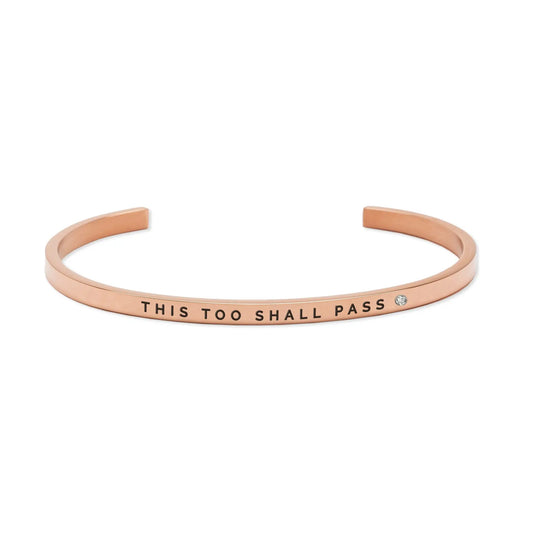 Gold bracelet with This Too Shall Pass engraved, symbolizing life's transient nature. Adjustable, durable stainless steel, 3mm width. Available in silver, rose gold.