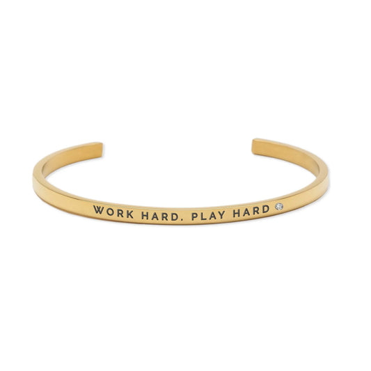Adjustable gold bracelet engraved with Work Hard. Play Hard motto, emphasizing life's balance. Durable, lightweight stainless steel polished for longevity. Width: 3mm. Available in silver and rose gold.