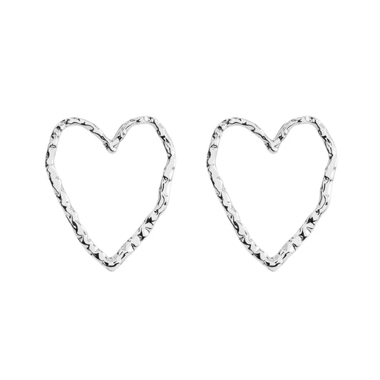 Minimalistic heart-shaped Eros silver stud earrings made from recycled silver. Hypoallergenic and comfortable for all-day wear. Materials: brass, 925 sterling silver pin, rhodium plated.