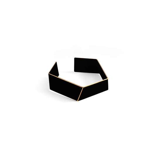 A black box with a yellow border showcasing the Folded Bracelet from Lisa Kroeber Jewellery, handcrafted in Europe from powder-coated brass for timeless elegance and sophistication.