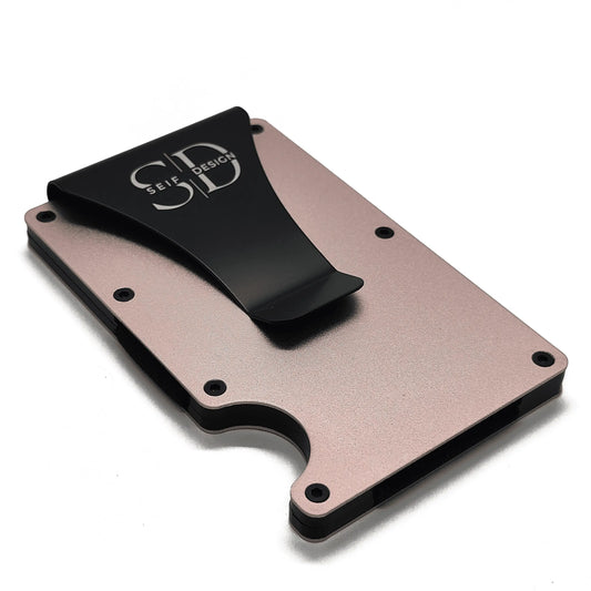 A close-up of a sleek aluminum card holder with RFID blocking technology, featuring a logo, from Seif Design. Environmentally friendly packaging.
