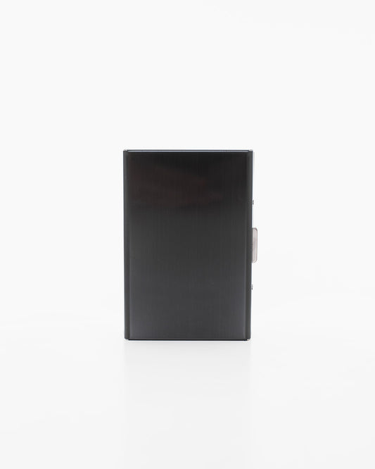 Black metal card holder by Nabo, a Finnish brand. Rectangular with 6 slots, measuring 9.5 x 6.5 x 1.2 cm. Sleek design with metal surface and lock detail.
