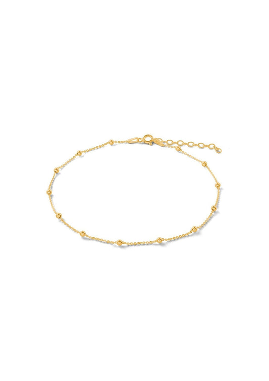 A minimal Mini Bubble Anklet in gold, featuring a silver chain with delicate bubbles. Hand-made with sterling silver coating and 24k gold plating, adjustable length, and sustainable packaging.