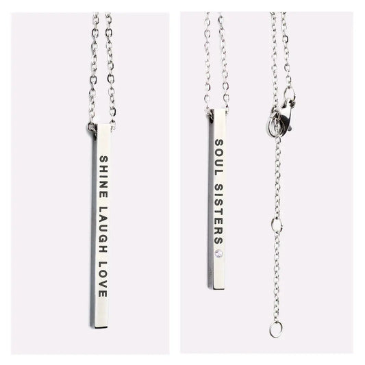 Silver rectangular necklace with SOUL SISTERS and SHINE LAUGH LOVE inscriptions. Durable stainless steel pendant, 50 cm chain length. Ideal for cherished bonds and positive vibes.