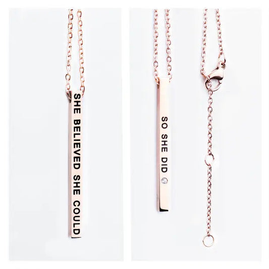 A stainless steel necklace with pendant featuring SHE BELIEVED SHE COULD and SO SHE DID engravings. Polished for durability, 50 cm long, available in silver, rose gold, and gold.