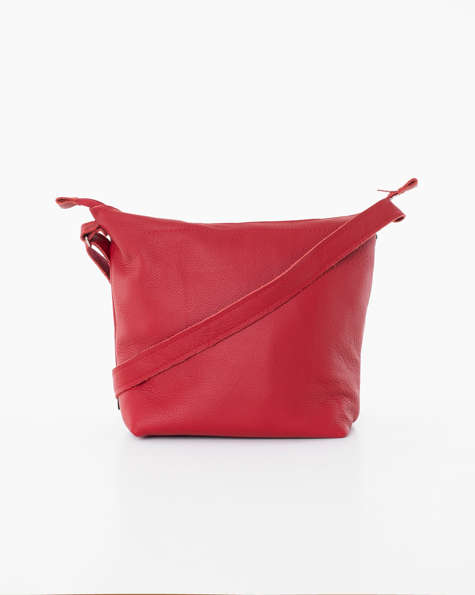 Handmade Suvi XS red leather shoulder bag with zippered compartments, crafted from furniture industry leftovers. Unique design from Estonia.