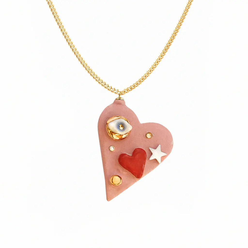 A heart-shaped necklace with an Eye of Protection charm, gold chain, and star pendant. Hand-made ceramic heart, 24K gold lustre, Swarovski crystal. Unique variations possible.
