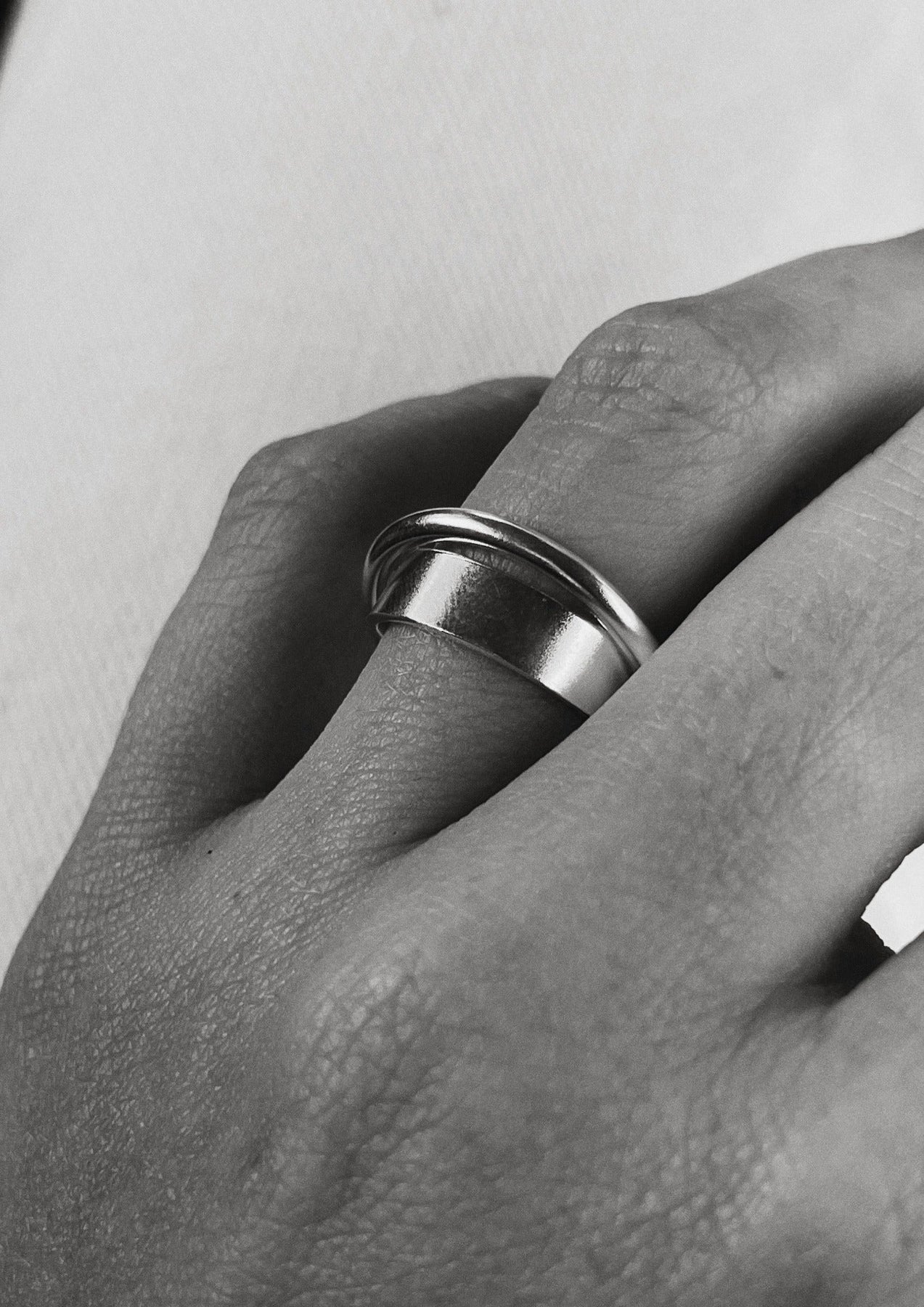 A close-up of a hand wearing the Andromeda Ring in sterling silver, showcasing intricate details and cosmic inspiration. Hand-crafted with care in Europe, this unique ring invites dreamers to spin and believe.