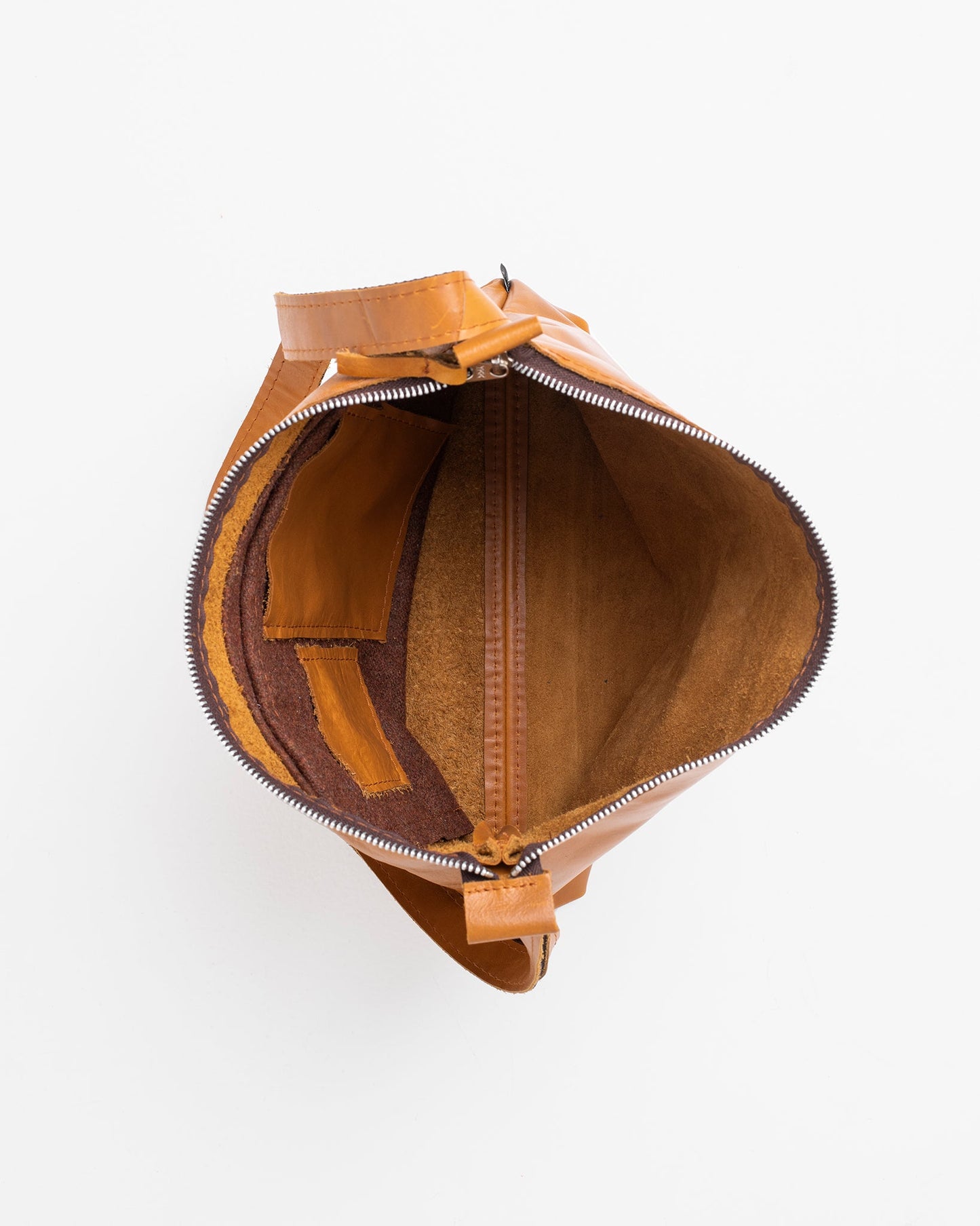 Handmade caramel leather shoulder bag, Anet L, crafted from high-quality furniture leftovers, each unique due to handmade process. Designed and made in Estonia.
