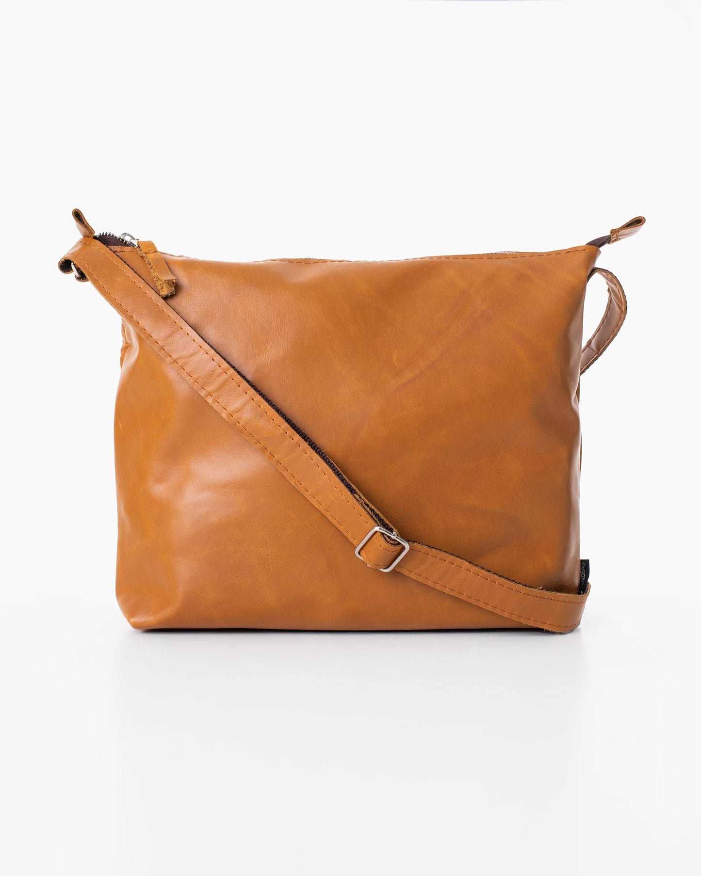 Handmade Anet L shoulder bag crafted from furniture industry leftovers, showcasing brown leather with a strap. Unique, eco-friendly design from Estonia.