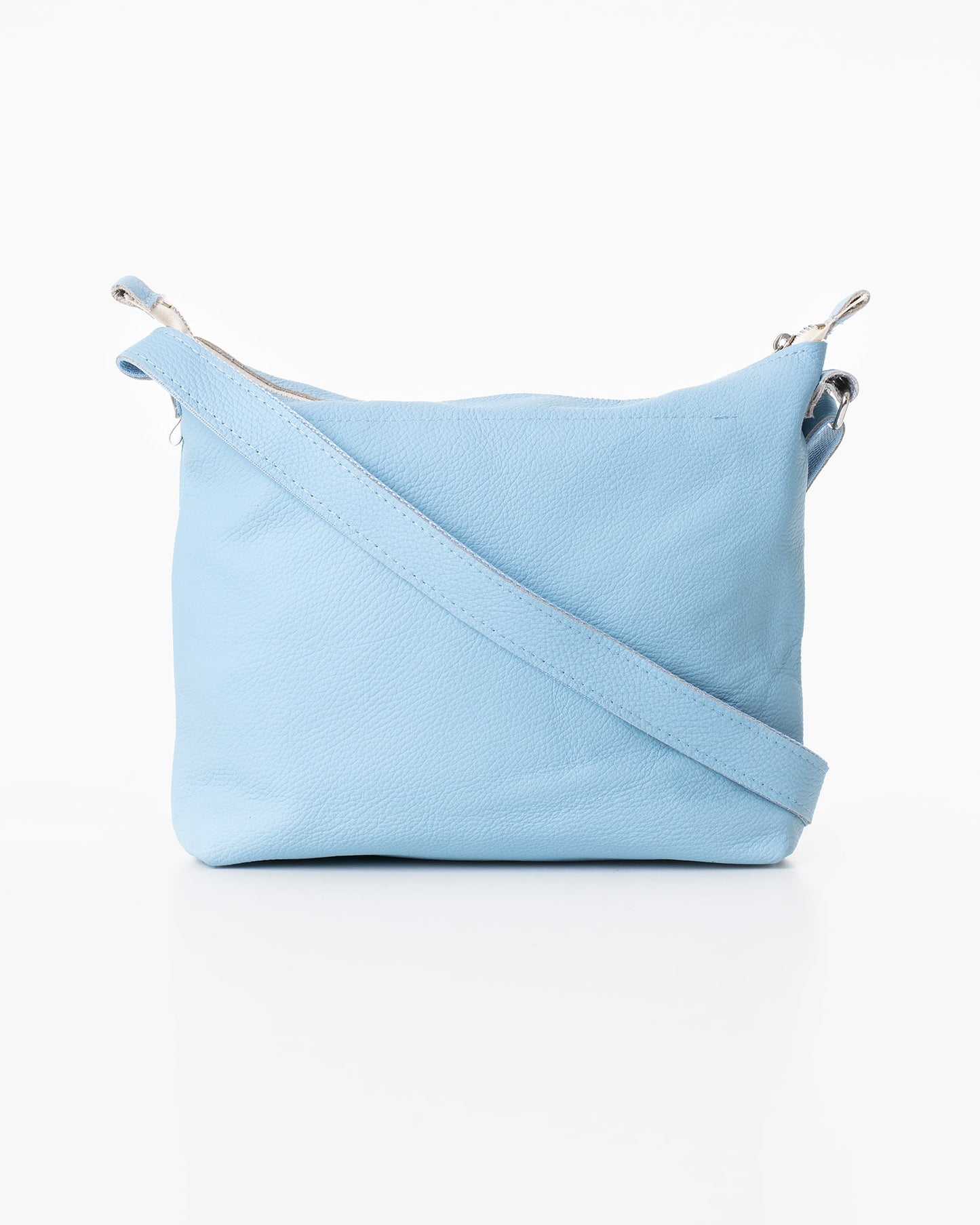 Handmade Anet L shoulder bag crafted from furniture industry leftovers, showcasing a light blue purse with a strap. Unique, eco-friendly, and durable design from Estonia.