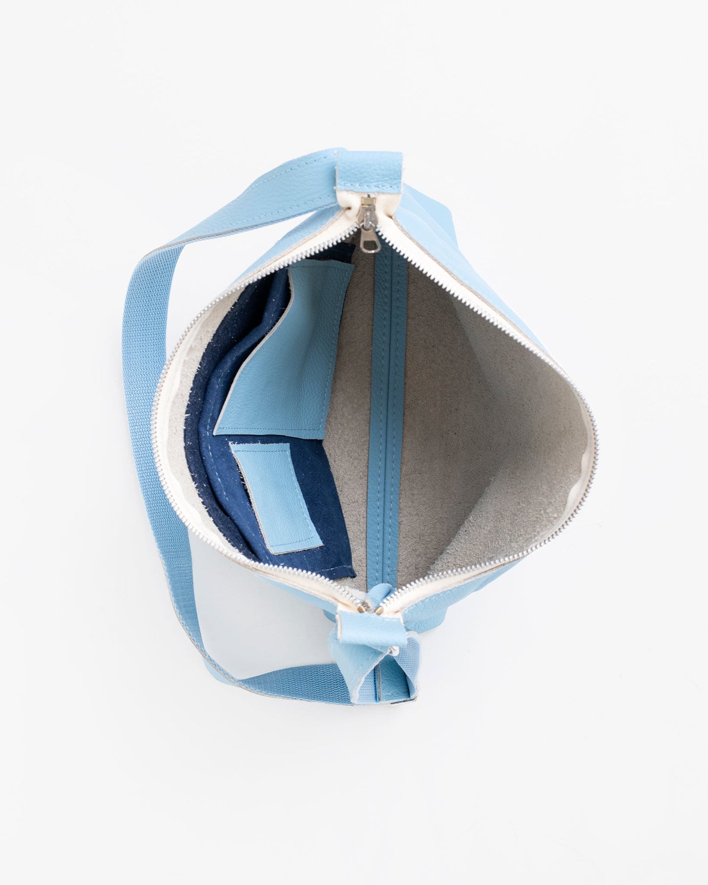 Handmade Anet L shoulder bag crafted from blue and white leather remnants, showcasing unique textures and eco-friendly design from Trendbag in Estonia.