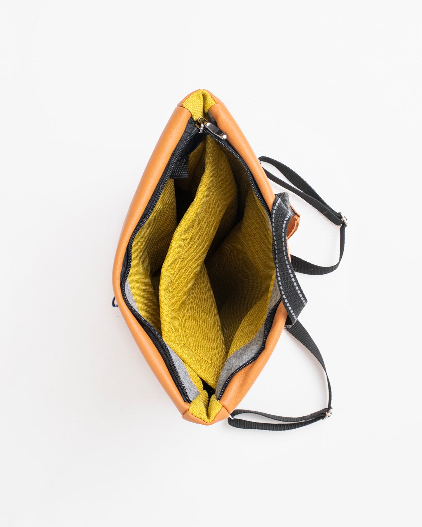 Handmade Barbara Leather Backpack - Calvados crafted from furniture leftovers, featuring a yellow interior, strap, and zipper. Designed and made in Estonia, eco-friendly and durable.