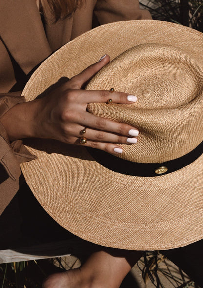 A hand with gold-plated Big Bomb Multisize Ring, featuring 6mm and 10mm bubbles on a 1.8mm band. Made sustainably in Lithuania, fits various ring sizes.