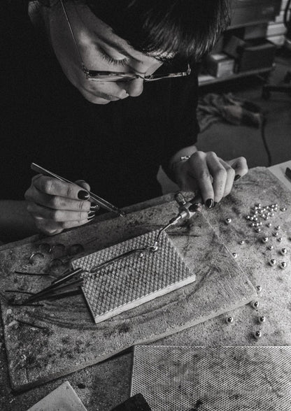 A person crafting a Silver Big Bomb Multisize Ring, featuring 6mm and 10mm hollow bubbles on a 1.8mm band. Handmade in Lithuania from sterling silver. Sizes: S (14-15.5), M (16-18.5), L (19-20.5).