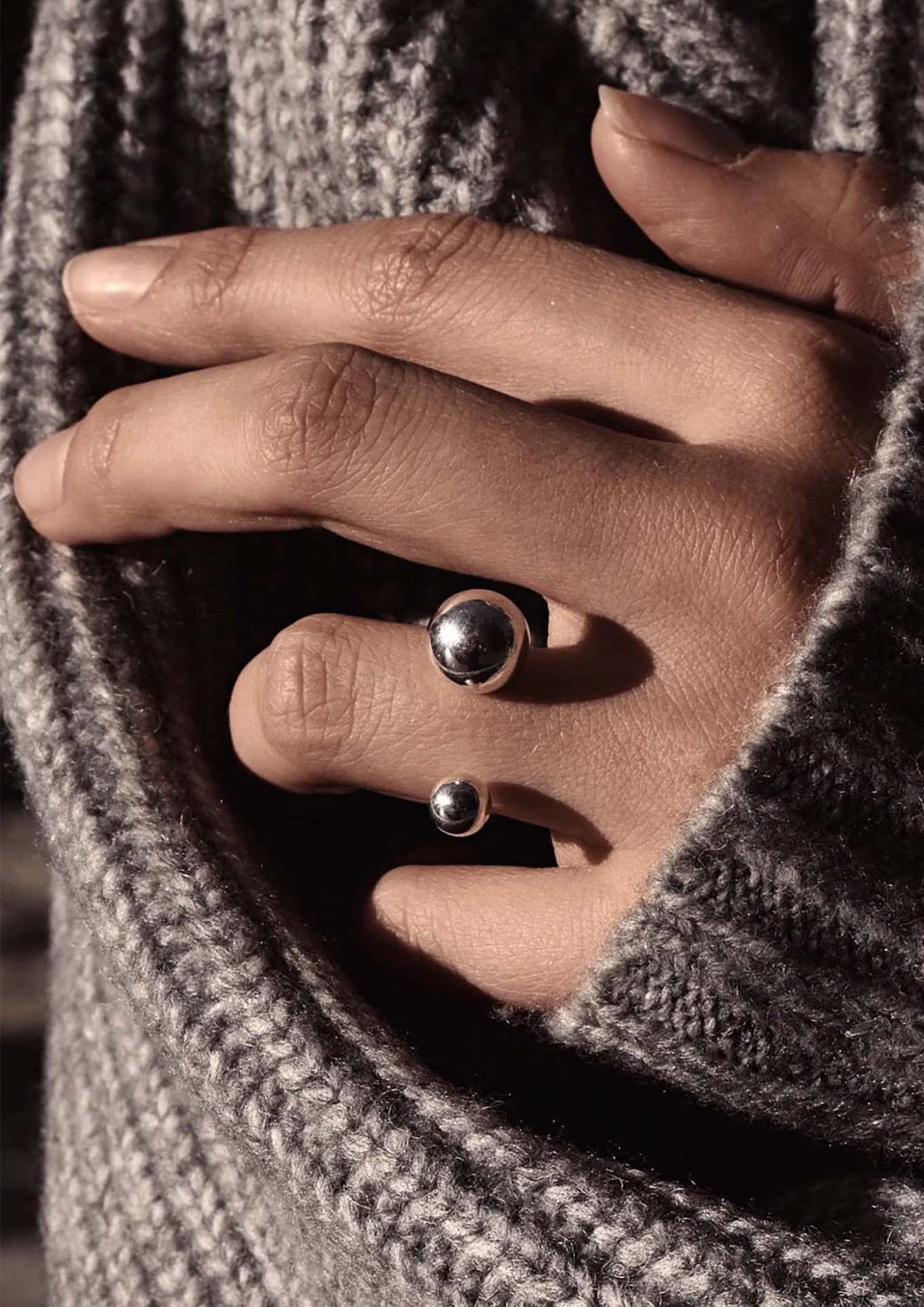 A hand wearing a Big Bomb Multisize Ring in Silver, featuring 6mm and 10mm hollow bubbles on a 1.8mm band. Hand-made in Lithuania from sterling silver.