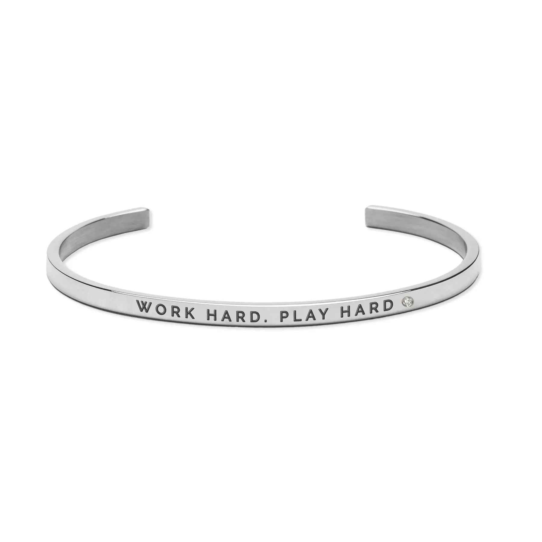 Silver bracelet with engraved words Work Hard. Play Hard. Adjustable, durable, and lightweight. Polished stainless steel. Encourages life balance and engagement. Width: 3mm. Available in silver, rose gold, gold.