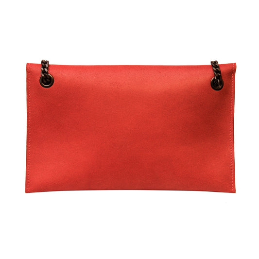 A red leather shoulder bag with a chic black chain strap, flap front, and magnetic clasp closure. Handcrafted in Europe with a two-section interior for organization.