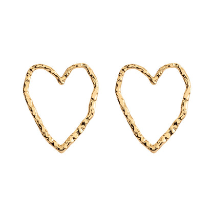 Gold heart-shaped Eros stud earrings by ONEHE. Minimalistic, sustainable design made from recycled silver, 18k gold plated. Hypoallergenic and easy to wear. Ideal for everyday elegance.