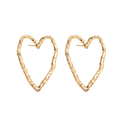 Minimalistic gold heart-shaped EROS stud earrings from ONEHE. Sustainable, hypoallergenic, and comfortable for all-day wear. Made from recycled silver, 18k gold plated. Ideal for a unique, elegant look.