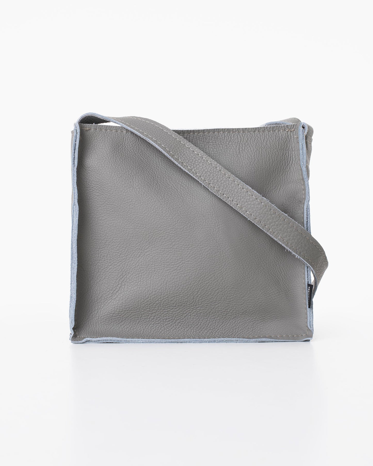 Handmade Folk 1 shoulder bag in light grey leather, crafted from furniture industry leftovers in Estonia. Unique design, eco-friendly, and durable.