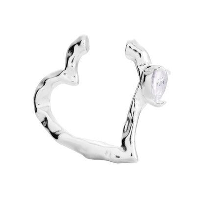 A heart-shaped silver ear cuff with a diamond-like stone. ONEHE sustainable, hypoallergenic accessory made from recycled silver. Elegant, minimalist design for unique style.