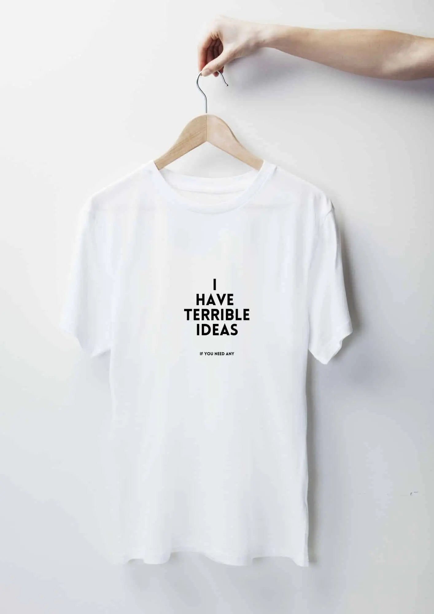 Oversized white t-shirt with black text I Have Terrible Ideas. Made of organic cotton. Features size chart for XS to XL. Washing instructions included.