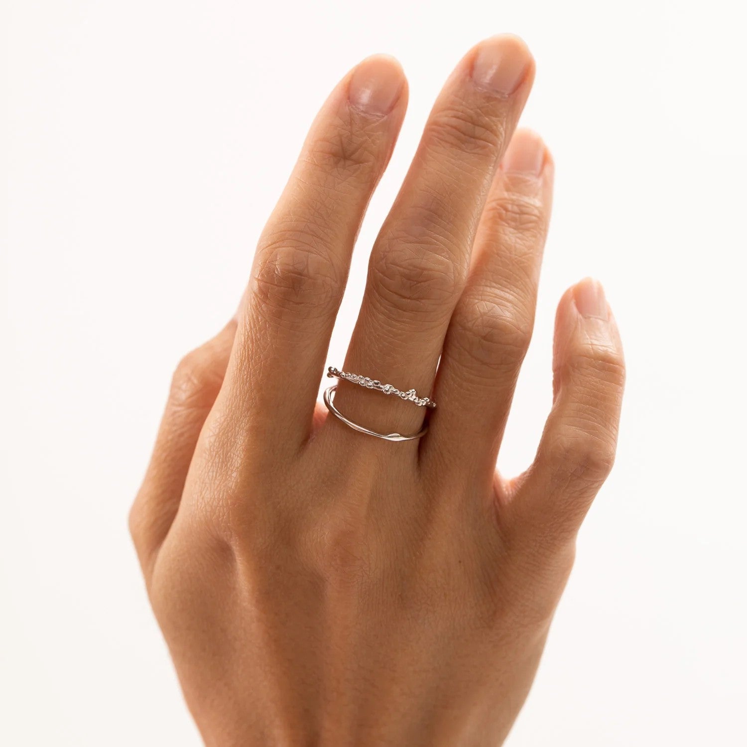 A resizable silver ring featuring a minimalist design, made of 925 sterling silver and rhodium plated. Hypoallergenic and elegant for all occasions.