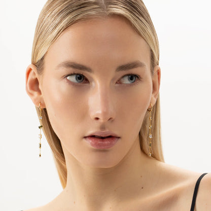 A close-up of a woman's ear wearing Hoop Earrings CASCADE in gold, showcasing elegant and sustainable design with hypoallergenic materials like 925 sterling silver and 18k gold plating.
