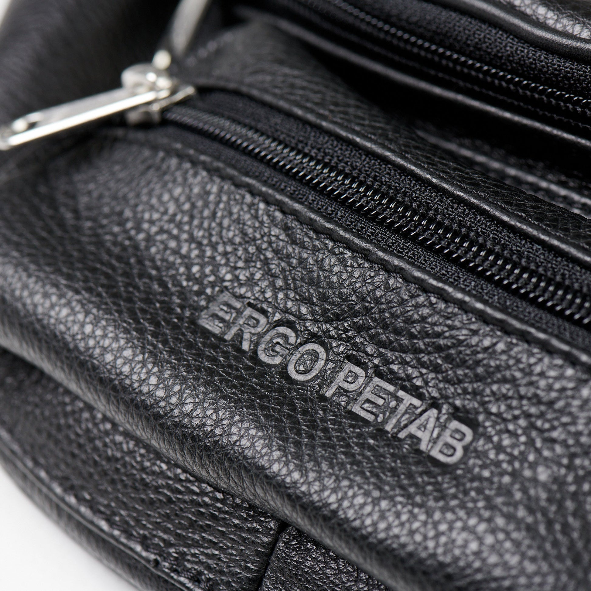 A black leather waist bag with zipper closures, adjustable strap (82-113 cm), main and front pockets, and a back compartment. Handcrafted in Europe, dimensions 30 x 13 x 10 cm.