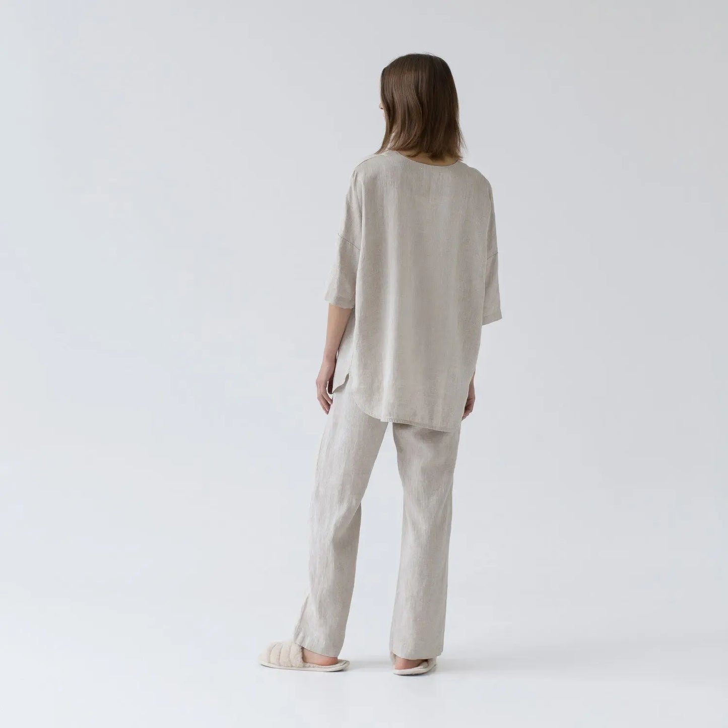 A woman in Linen Primrose Loungewear Set - Melange: white shirt, pants, V-neck, buttoned front, 3/4 sleeves, elastic waistband, slanted pockets, handmade 100% linen.
