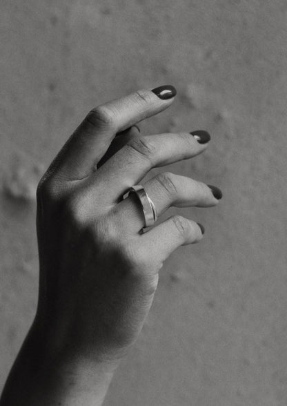 A hand wearing the unique Milky Way Ring in sterling silver, showcasing its cosmic-inspired design. Hand-crafted with care, featuring a spinning element for dreamers. Made sustainably in Lithuania.