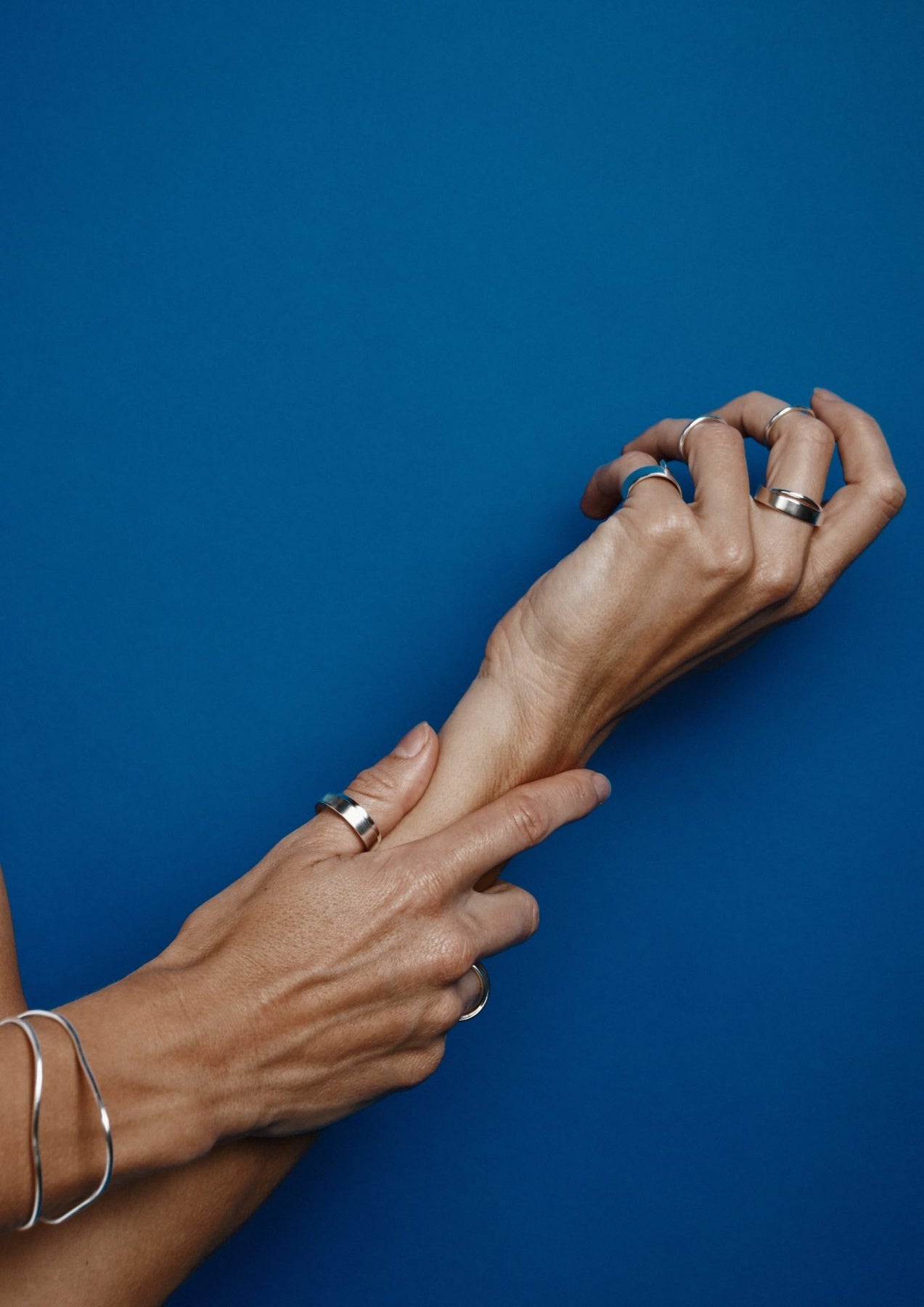 A close-up of a hand with the Milky Way Ring in sterling silver, showcasing intricate craftsmanship and cosmic inspiration. Handmade in Lithuania with sustainable packaging. Unique angles due to handcrafting.