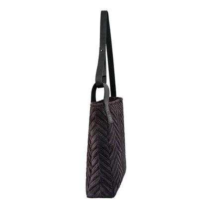 A black handbag with a strap, showcasing a herringbone design. Crafted from soft-touch fabric and genuine leather, featuring a zip closure and interior pocket for convenience. Dimensions: H37 x W30 x D10 cm.