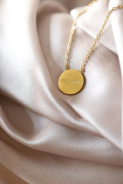 Gold necklace with round disc medallion, 49 cm length. Crafted from durable stainless steel, polished for lasting shine. Available in silver, rose gold. OLLA Necklace with Medallion - Good Vibes.