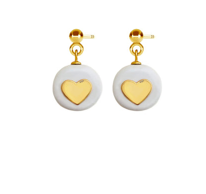 Hand-crafted Pure Love earrings: white ceramic hearts with 24K gold-over silver details. Each unique. Image shows heart earrings and a gold key.