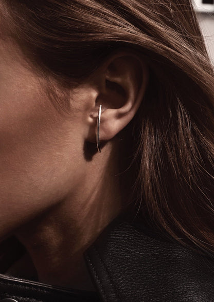 Close-up of Radius Earrings - Sterling Silver 925, 31.6mm length, 1.8mm thickness, push-back clasps. Handmade sustainably, elegant and captivating design.