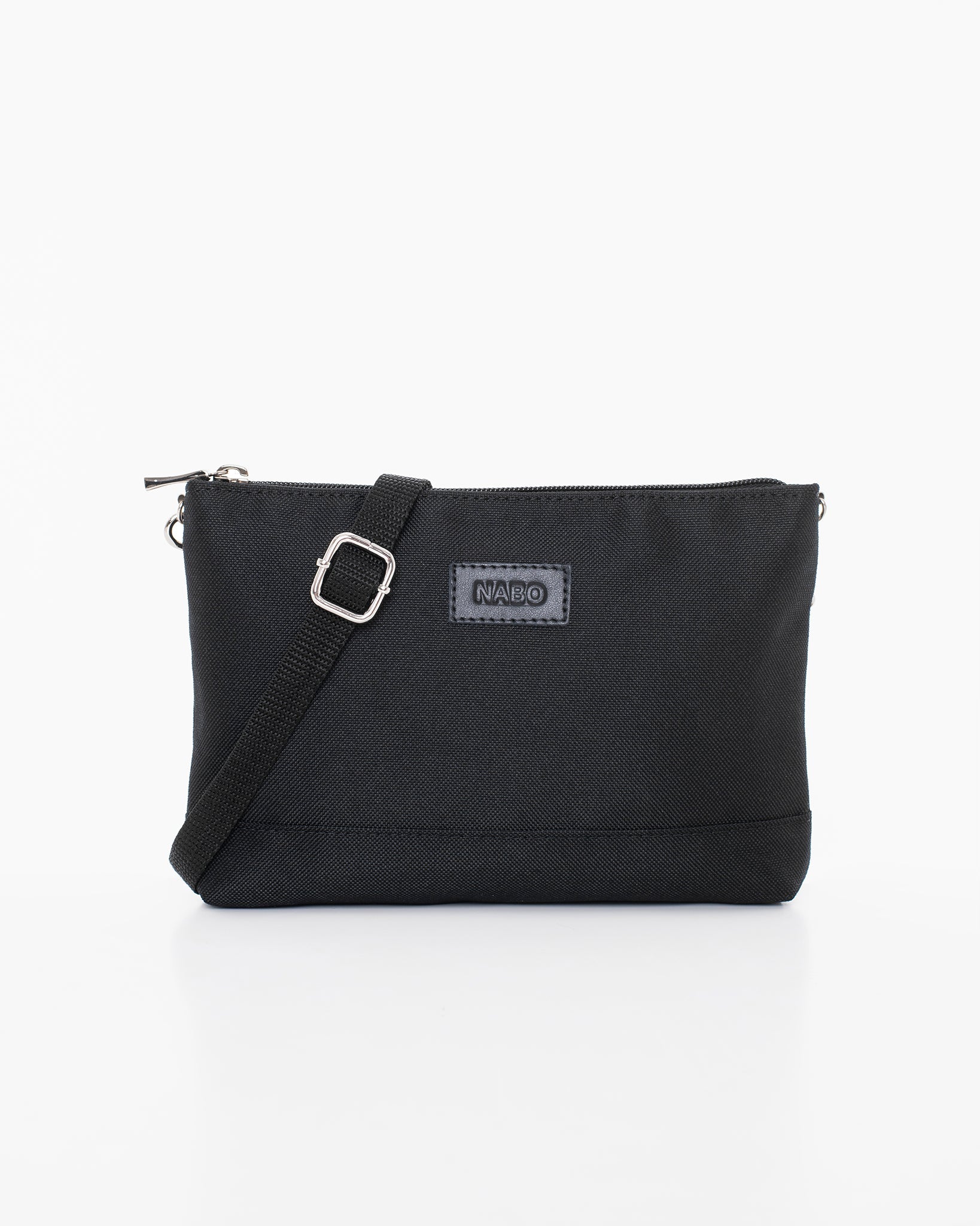 Shoulder Bag - Black by Nabo, a Finnish brand. Recycled polyester, multiple zip pockets, adjustable strap up to 145 cm. Versatile as waist bag. Dimensions: 22 x 15 x 3 cm.