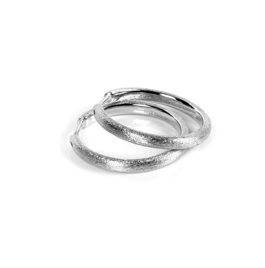 Sugar Hoops Earrings: Brushed silver hoops, polished inside, crafted from rhodium-plated 925 silver, 25mm diameter. Designed by MyaMoon for a simple, timeless style.